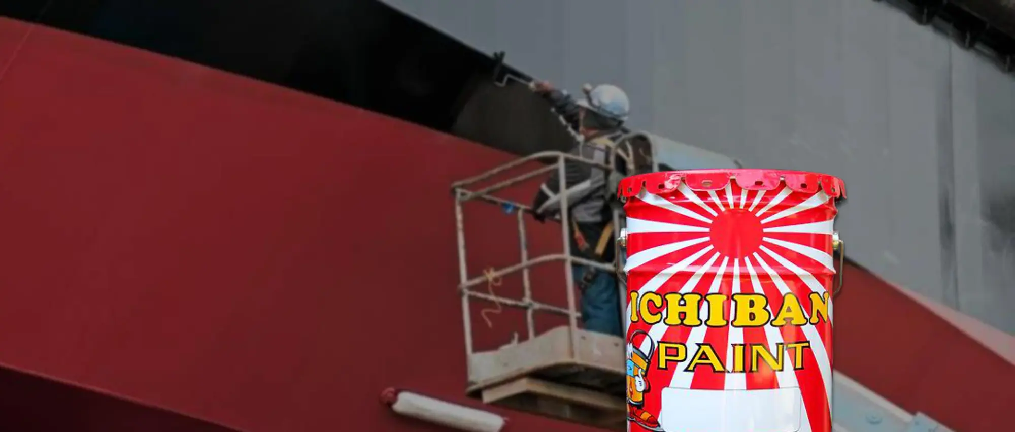 Applicator painting a ship hull with Ichiban Marine Paint